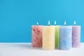 Alight wax candles on color background Royalty Free Stock Photo