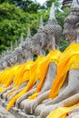 Aligned Buddha statues at Wat Yai Chaimongkol, Ayutthaya, Thailand. Royalty Free Stock Photo