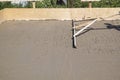alignment of fresh concrete slab with a special working tool Royalty Free Stock Photo