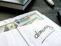 Alimony concept. Open envelope with cash on the desk. Royalty Free Stock Photo