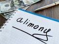 Alimony written on a notepad. Divorce and separation concept. Royalty Free Stock Photo