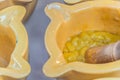 Alioli sauce being prepared in small yellow bowls