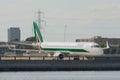 Alitalia regional airplane taxiing at London City Airport after landing