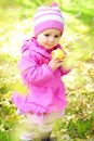 The little girl on a green glade with an apple Royalty Free Stock Photo