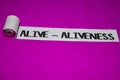 Alive - Aliveness text, Inspiration and positive vibes concept on purple torn paper