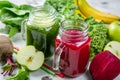 Alkaline diet concept - green and purple smoothies and ingredients