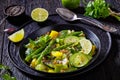 Alkaline green soup in black bowl, top view