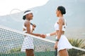 All the best on the court today. two sporty women shaking hands while playing tennis together on a court. Royalty Free Stock Photo