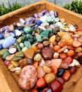 All Colour Colors Gemstone Polished Hand Palmstones Rocks in wooden Box Near Water Spiritual Royalty Free Stock Photo