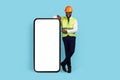 All For Construction. Happy Black Engineer Pointing At Big Blank Smartphone Screen