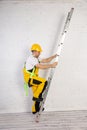 Irresponsible use of a ladder during construction work. Royalty Free Stock Photo