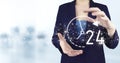 24 7 all day all night. Two hand holding virtual holographic 24 7 all day all night icon with light blurred background. Technical Royalty Free Stock Photo