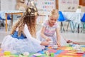 All dressed up for a tea party. two girls playing together in class. Royalty Free Stock Photo