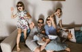 All family father with baby on his arms, mother and two daughters in the special glasses watching tv and eating popcorn Royalty Free Stock Photo