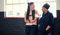 All about that fitness. two cheerful young women having a conversation before a workout session in a gym. Royalty Free Stock Photo
