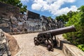 Replica cannon and defense wall of Mount Fortress, Fortaleza do Monte, between Nature. Santo AntÃÂ³nio, Macao, China. Asia Royalty Free Stock Photo