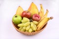 All fruits like Banana, Ripe Mango, Guava, Java Apple, Apple, Grapes in basket isolated on white background. Royalty Free Stock Photo