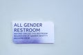 `All Gender Restroom` silver sign on a blue wall Royalty Free Stock Photo