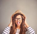 We all get a little crazy sometimes. Studio portrait of an attractive young woman screaming against a gray background. Royalty Free Stock Photo