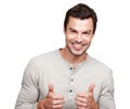 All good. Portrait of a handsome young giving you the thumbs up while isolated on white.