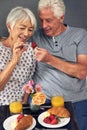 All happiness depends on a leisurely breakfast. a senior couple having breakfast in bed. Royalty Free Stock Photo