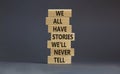 We all have stories we will never tell symbol. Blocks with words We all have stories we will never tell. Beautiful grey background