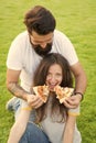 All for her. Fast food. Bearded man feeding woman cheesy pizza. Couple in love dating outdoors eat pizza. Hungry