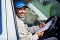 All his deliveries are running smoothly. Portrait of a happy delivery man driving his van. Royalty Free Stock Photo