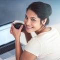 All I need is a little coffee. High angle portrait of an attractive young businesswoman drinking coffee while working on Royalty Free Stock Photo