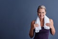 All I need is my time. Studio portrait of an attractive mature woman in sportswear standing with a towel around her neck Royalty Free Stock Photo