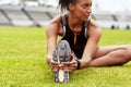 The all important warmup. an attractive young female athlete warming up at the track. Royalty Free Stock Photo