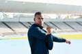 The all important warmup. a handsome young male athlete warming up out on the track. Royalty Free Stock Photo