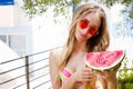 All Inclusive Cheap Summer Holidays. Young Happy Woman with Watermelon and pink sunglasses at beach Background. Summertime fun Royalty Free Stock Photo