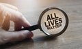 ALL LIVES MATTER. Anti racism concept. Equal symbol. Inscription under magnifyer on wooden table. Stop racism