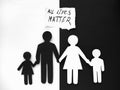 All lives matter, symbol of an interracial family cut out of black and white paper. no to racism. Mixed race family set