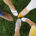 All the members of a family putting their feet together on the grass. Aerial photo Royalty Free Stock Photo