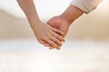 We all need someone to take long walks on the beach with. Closeup shot of an unrecognizable couple holding hands on the