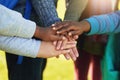 All for one and one for all. Shot of a group of unrecognizable elementary school kids joining their hands together in a