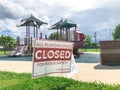 All playgrounds closed for public safety sign as Coronavirus with colorful kid park in background Royalty Free Stock Photo