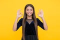 All right and alright. Child show OK signs yellow background. Happy girl smile with satisfaction. Agreed and acceptable