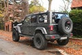 Big black high 4x4 offroad car Jeep Wrangler Sahara five door parked