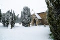 All Saints church in the small village of Sutton in the British countryside, it is totally covered in deep snow during a rare snow Royalty Free Stock Photo