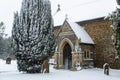 All Saints church in the small village of Sutton in the British countryside, it is totally covered in deep snow during a rare snow Royalty Free Stock Photo