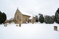 All Saints church in the small village of Sutton in the British countryside, it is totally covered in deep snow during a rare snow Royalty Free Stock Photo