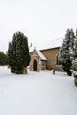 All Saints church in the small village of Sutton in the British countryside, it is totally covered in deep snow during a rare snow Royalty Free Stock Photo