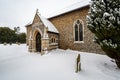 All Saints church in the small village of Sutton in the British countryside, it is totally covered in deep snow during a rare snow Royalty Free Stock Photo