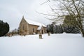 All Saints church in the small village of Sutton in the British countryside, it is totally covered in deep snow during a rare snow Royalty Free Stock Photo