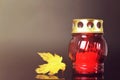 All Saints Day. Burning candle and autumn leaf