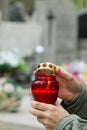 All Saints` Day and christian hands with candle light of memory on cemetery Royalty Free Stock Photo