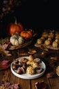 All Saints Day marzipan sweet panellets and roasted chestnuts, autumn leaves on wooden table Royalty Free Stock Photo